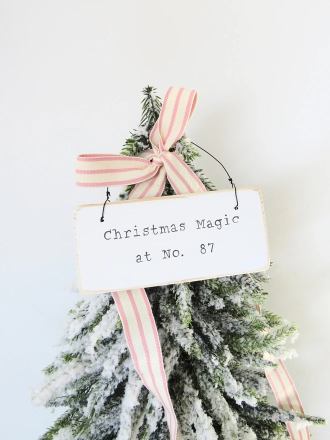 Chalky white painted wooden hanging sign with hand painted personalised Christmas Magic message