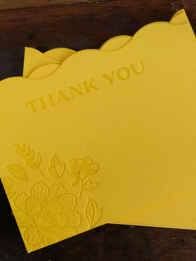 Wavy die-cut citrus yellow card with peony illustration and 'Thank you' debossed into the card. 