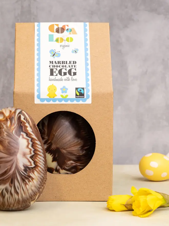 Chocolate marbled easter egg in a box on a table