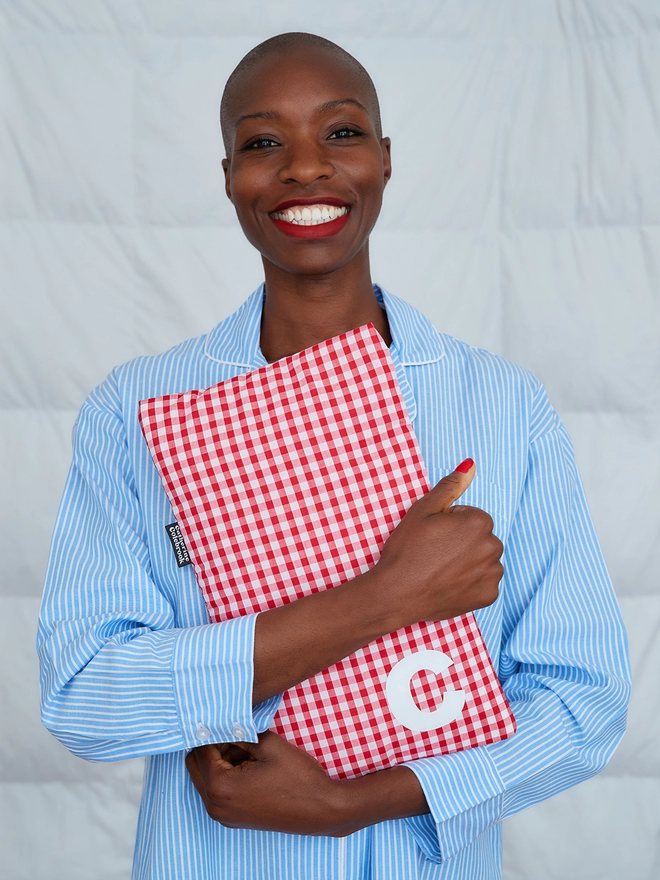 Red gingham hot water bottle with white initial