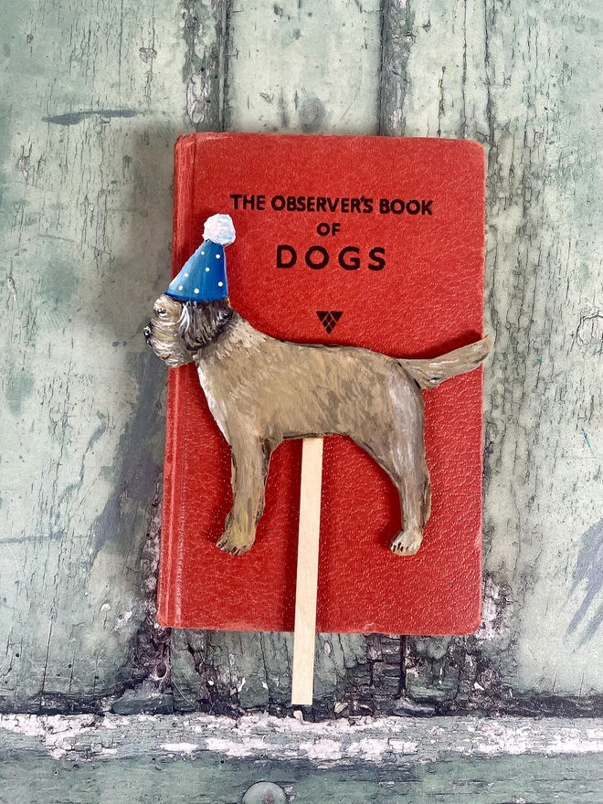 Border Terrier Hand Painted Wooden Cake Topper with a blue hat