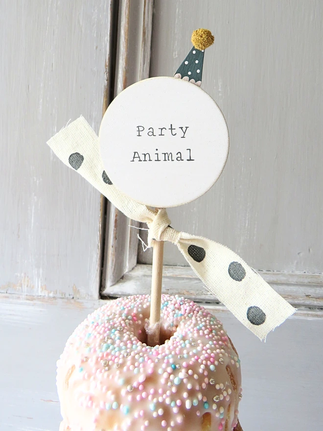 hand painted wooden cake topper with party animal message and hand made party hat