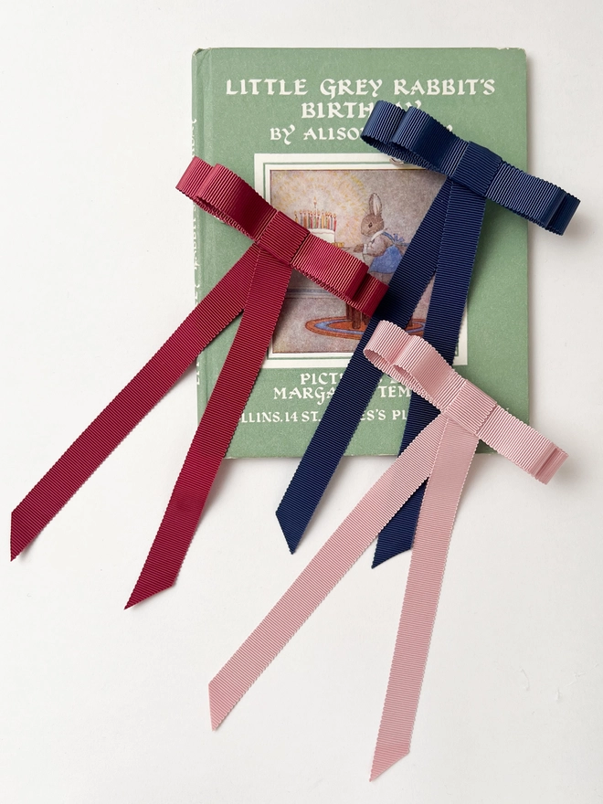 All the hair bows on a vintage book