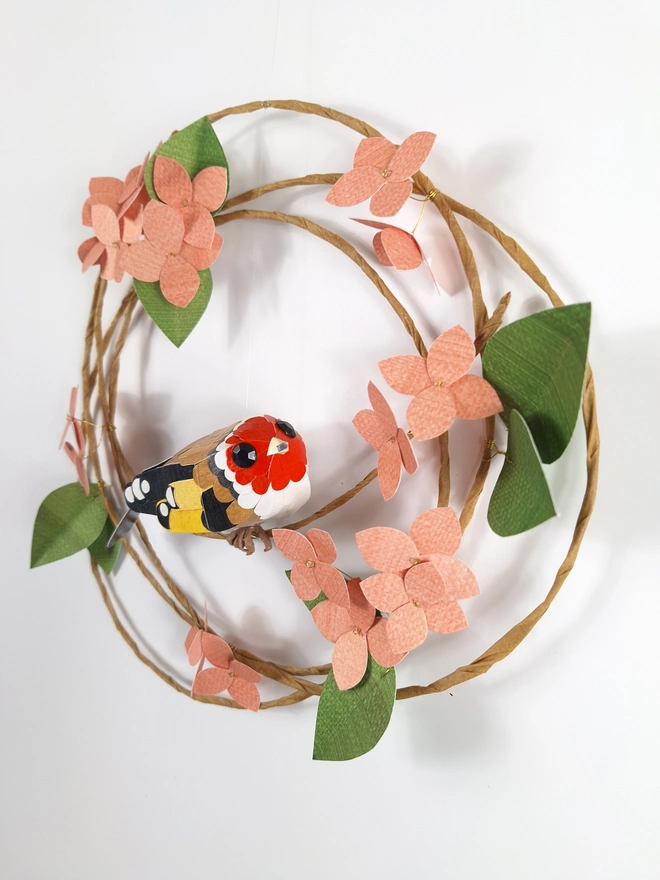 handmade goldfinch on a floral wreath of peach hydrangea