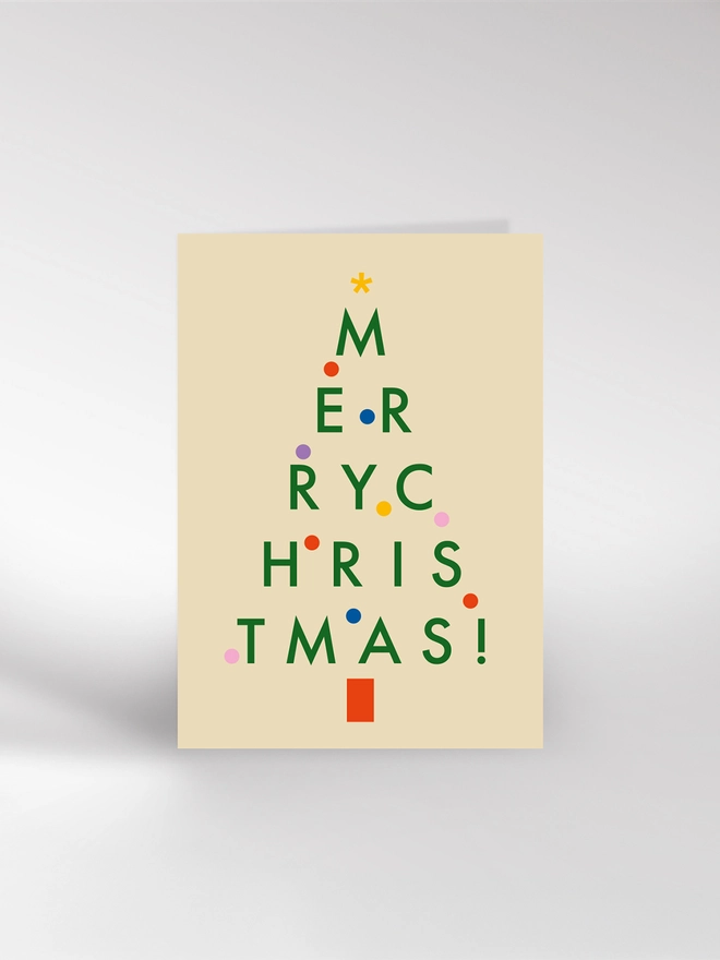A Christmas card featuring a tree made up of letters, spelling out Merry Christmas!