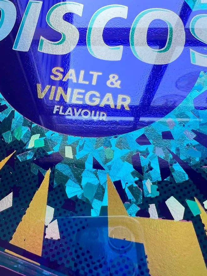 'Disco Salt & Vinegar Flavour' ScreenPrint, a colourful discos print sitting in a gold frame held by a person. 