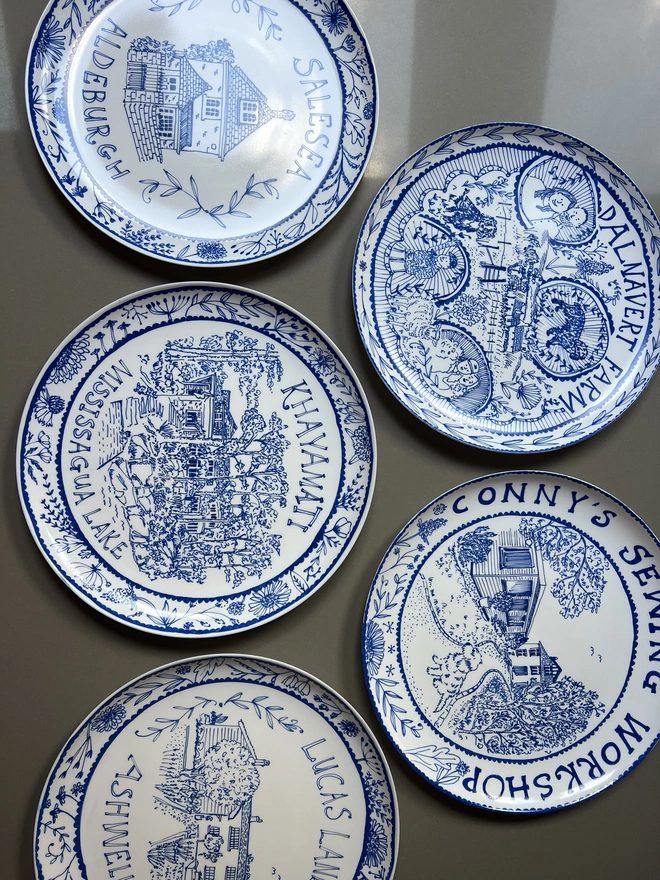 A selection of personalised large blue and white house plates by Circle of Willis