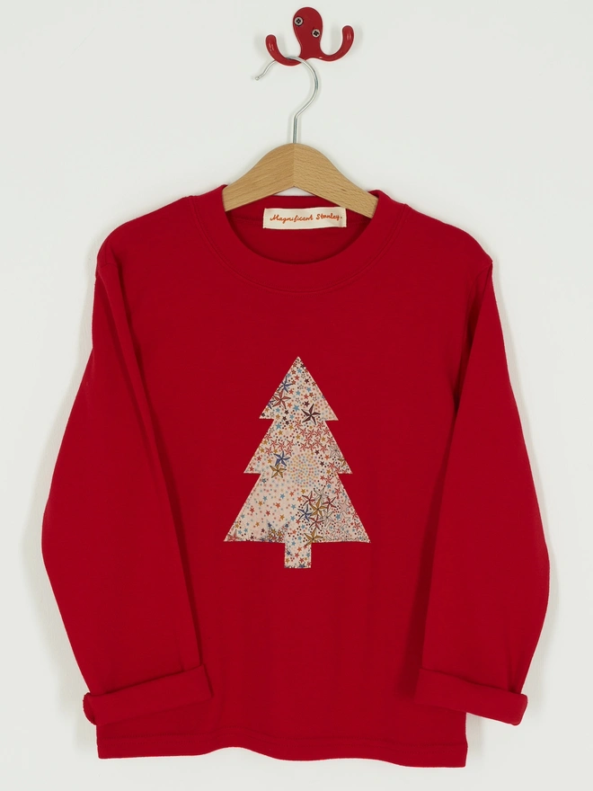 a red Christmas tee with a christmas tree cut from starry liberty print sewn onto the front