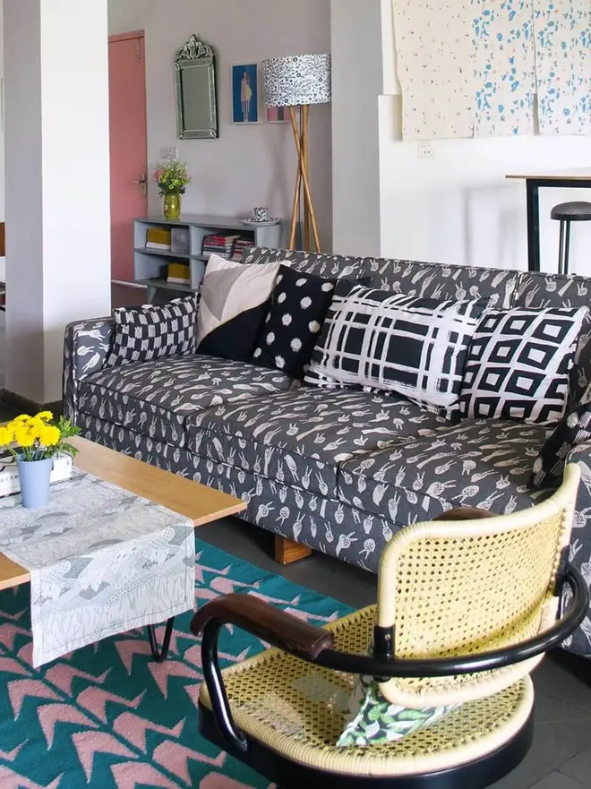 Crane Flatweave Rug, a colourful rug sitting in a living room. It is accompanied by other colourful items. 