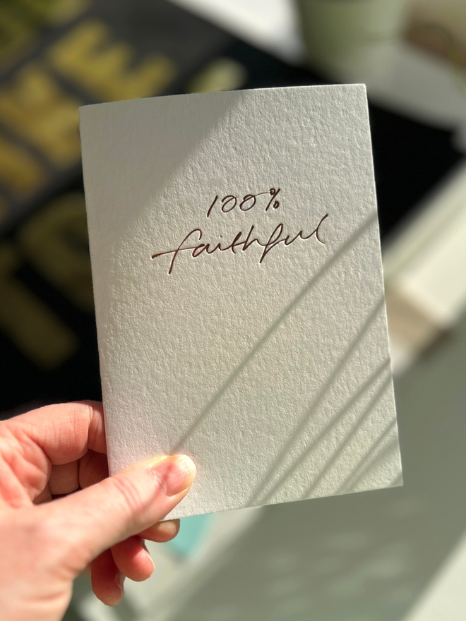 handfoiled luxury card that has 100% faithful written on the front stamped in rose gold foil - inspired by the hit BBC show The Traitors