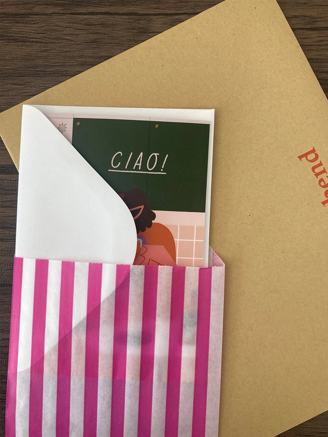 Greetings card packed with a white envelope inside a paper bag