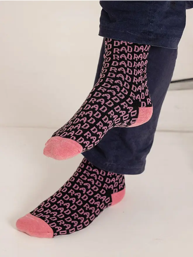 Charcoal Rad Dad socks with rad dad written in pink 