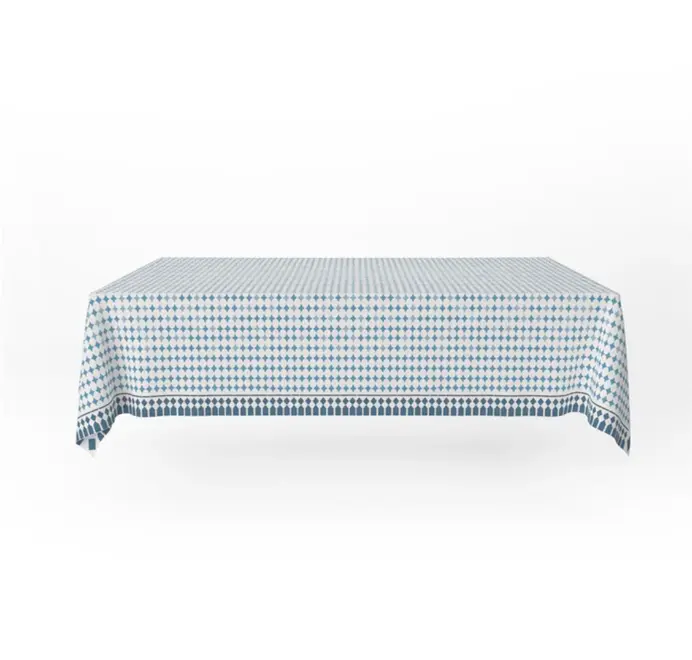 Casa Azul Tablecloth. Blue geometric Casa Azul tablecloth displayed on a table against a white background. 