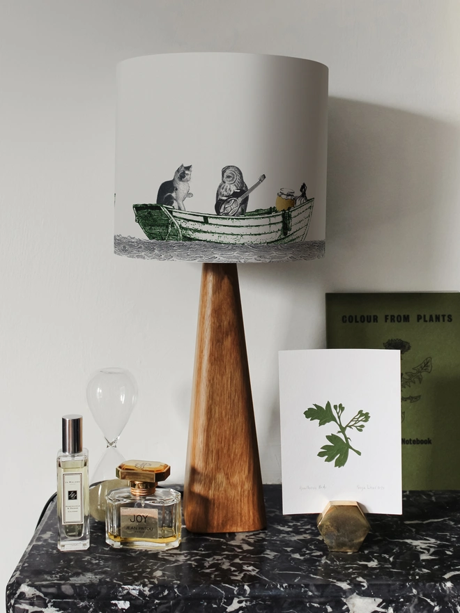 Handcrafted Owl and the Pussycat lampshade featuring a whimsical pea green boat illustration, bringing a touch of nostalgic storybook charm to the home.
