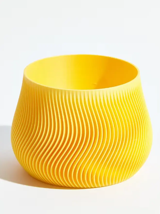 Sustainable 3D Printed Banana Yellow Plant Pot, groovy design against a white background.
