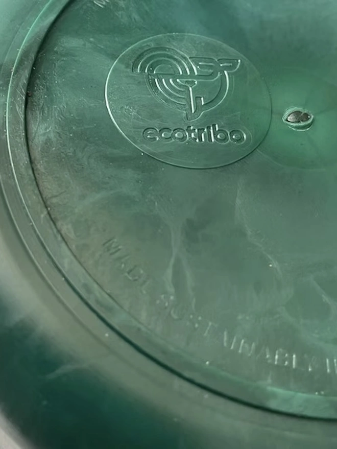 Ocean Plastic Plant Pot Small, a green recycled plant pot sitting on a white surface against a plain backdrop. 