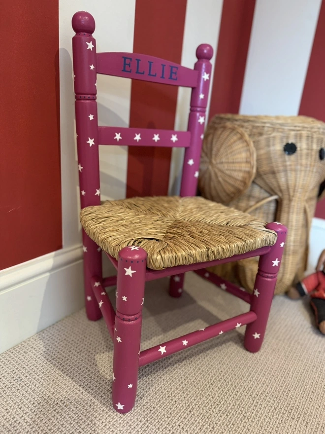 Pink hand painted child’s chair in nursery. 