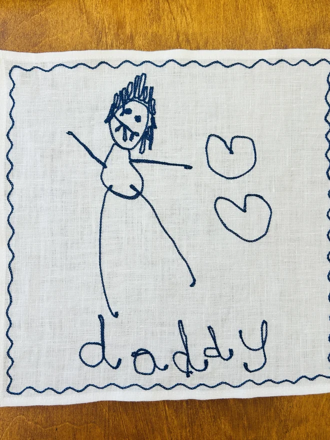 child's drawing embroidered onto linen white handkerchief dark blue thread