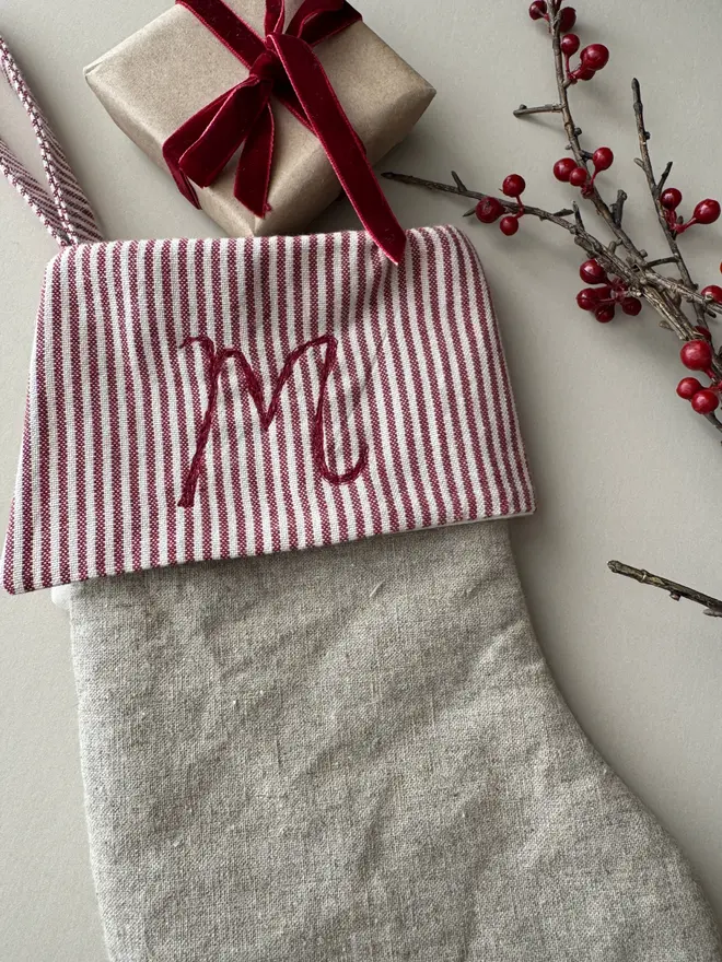 Red and white striped stocking with a small gift and red ribbon