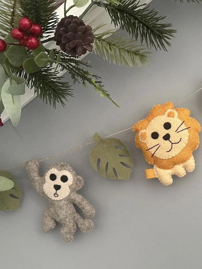 Nursery Safari Garland, a safari themed garland hanging in a child's bedroom against a grey backdrop. 