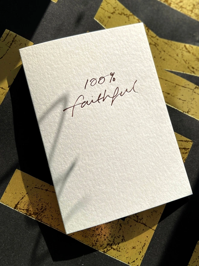 handfoiled luxury card that has 100% faithful written on the front stamped in rose gold foil - inspired by the hit BBC show The Traitors