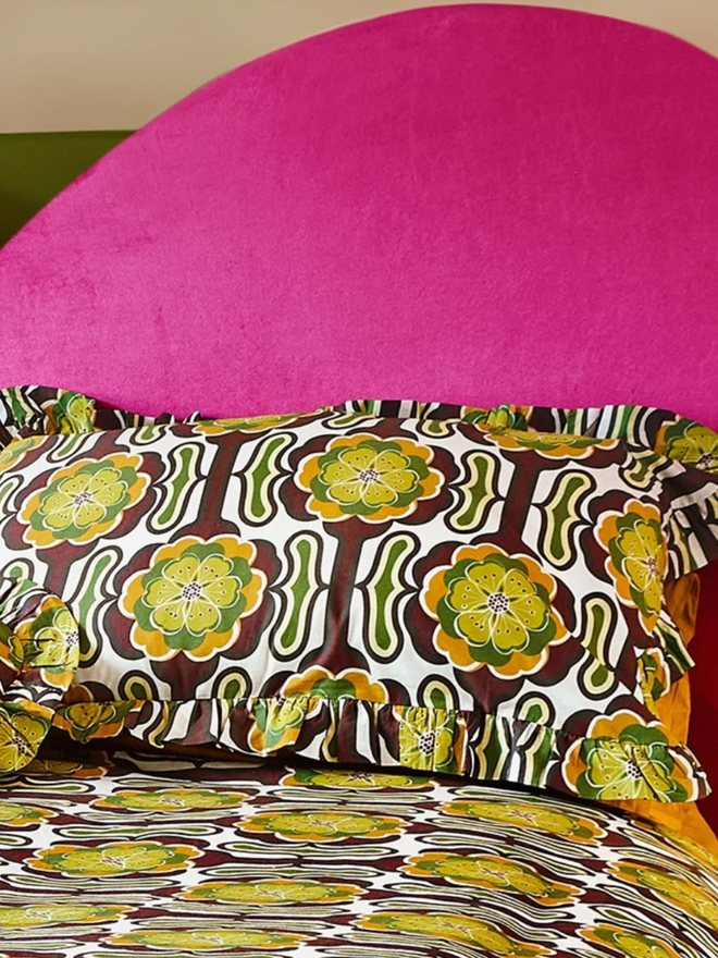 Thelma Pillowcases. Green, brown, white, and black retro-patterned pillowcases.