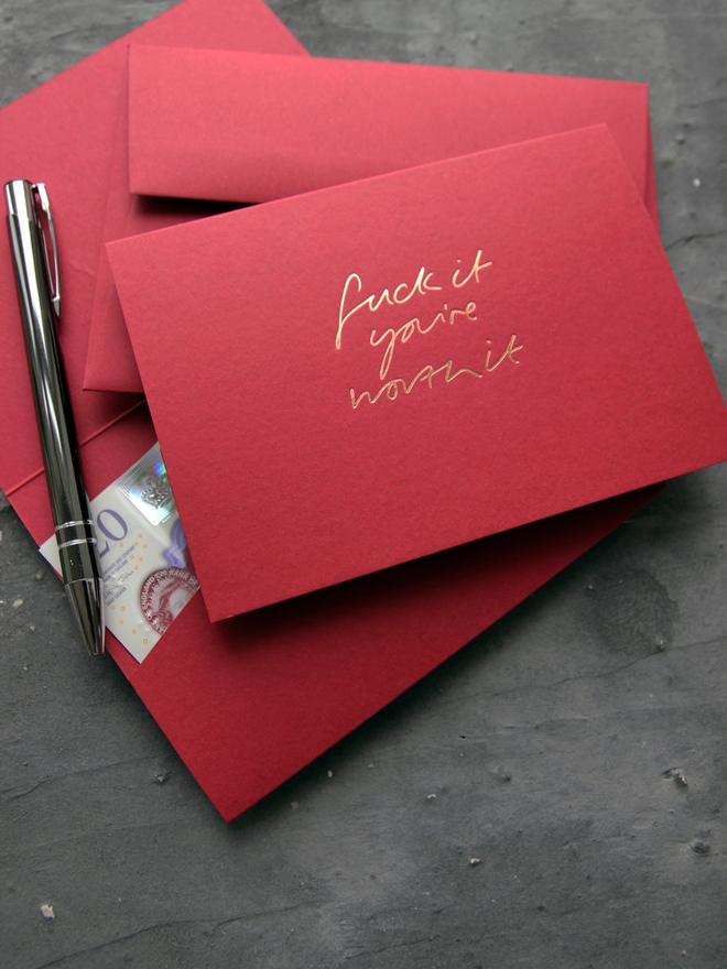 Fuck It You're Worth It cash card in scarlet with rose gold foil and matching envelope