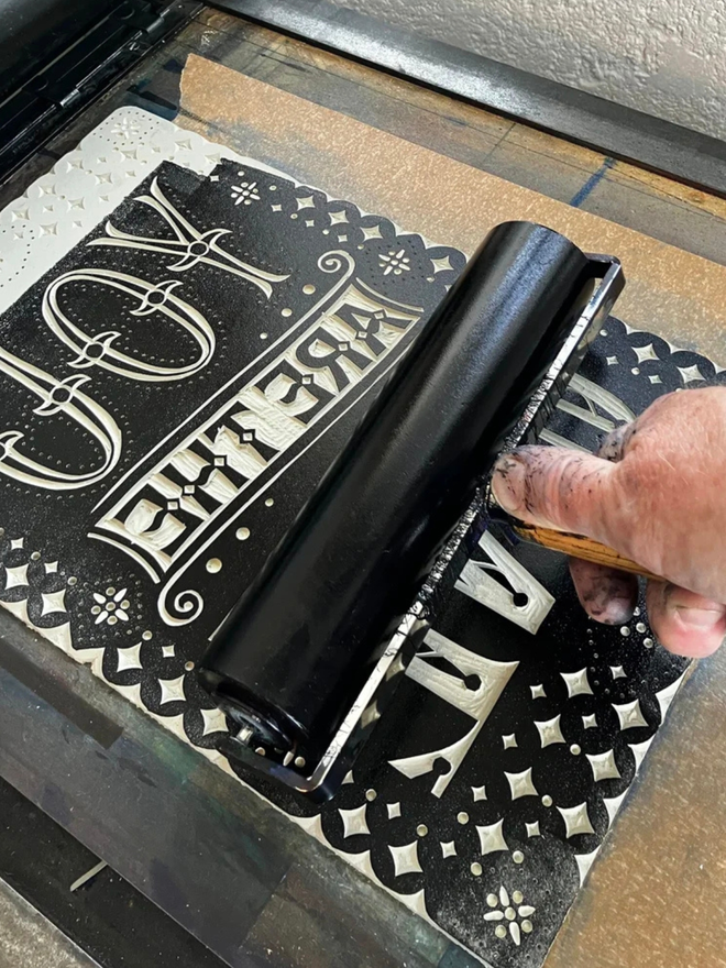 you are the one linocut. a linocut phrase printed on black paint.