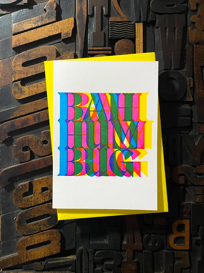 Bah Humbug! A beautiful typographic letterpress Christmas card set. Printed with rich vibrant and fluorescent blue, magenta and yellow inks with luxury matching and contrasting envelopes; ideal to send to your designer friends.