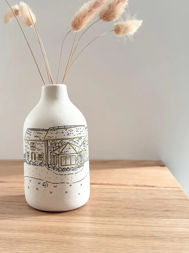 Custom Wedding Venue Hand Drawn Vase with dried flowers coming out of it on a wooden table