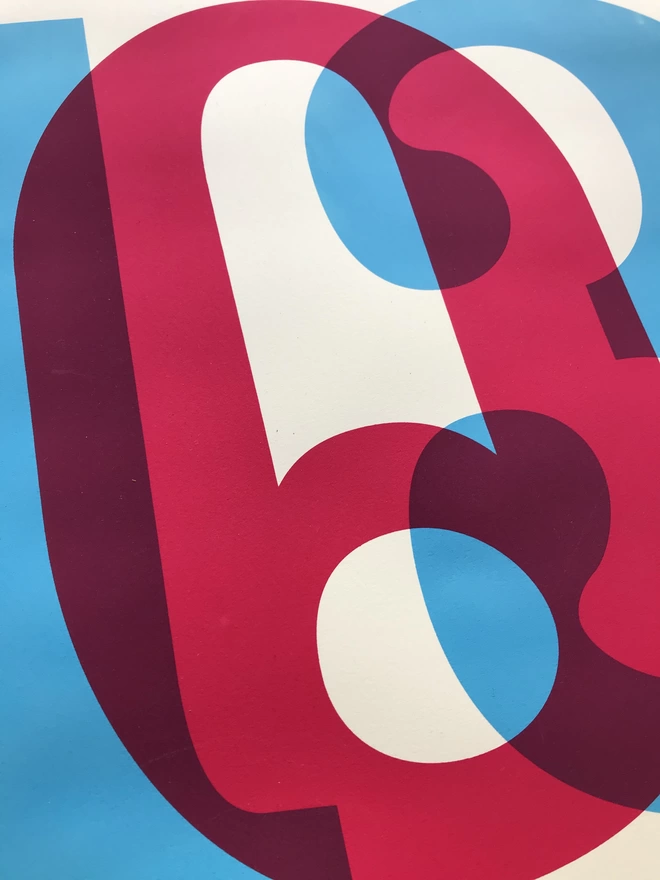 Close up of magenta and cyan ink overlapping to make a purple. Big letters of a postcode screenprinted on white paper