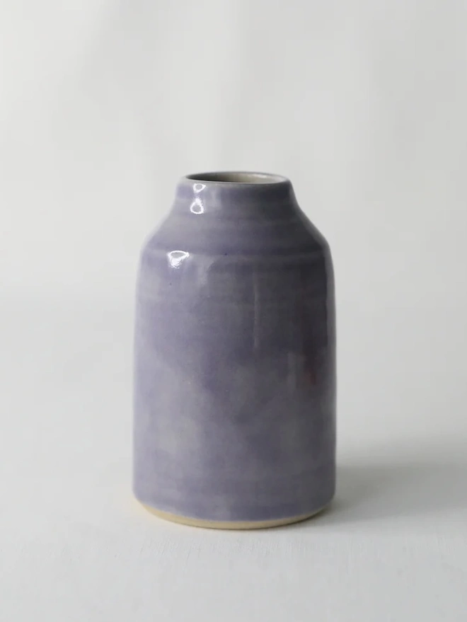 Classic Bud Vase, a colourful ceramic vase sitting on a plain surface against a white backdrop. 