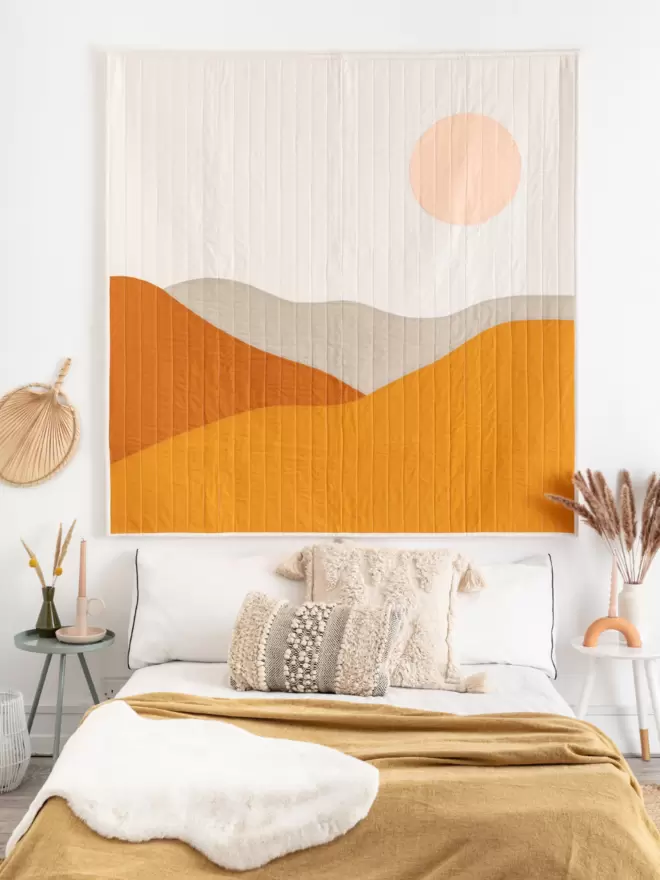 Desert Quilt Hanging Above Bed in Bedroom