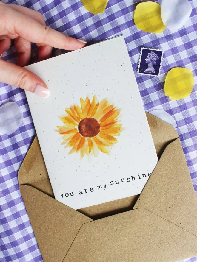 'You Are My Sunshine' Card laying on Kraft envelope and lilac gingham cloth