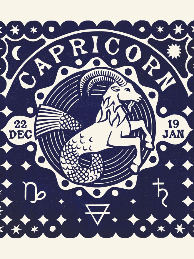 capricorn zodiac linocut. a linocut goat and zodiac symbols printed on a blue background.