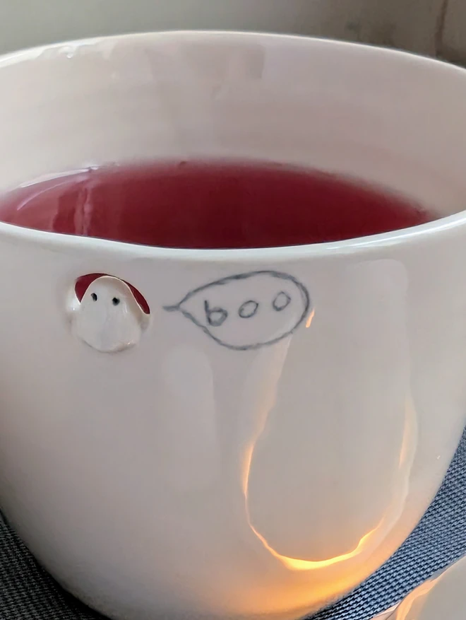 white ceramic ghost beaker with a tiny ghostie and the word boo in a speech bubble
