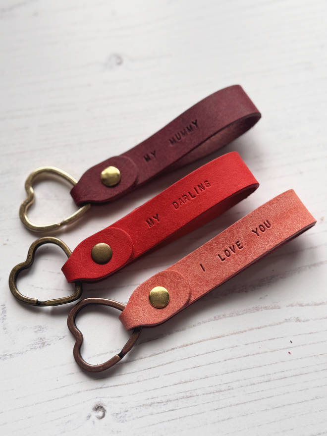 Leather keyring with mini text in pink, red and burgundy