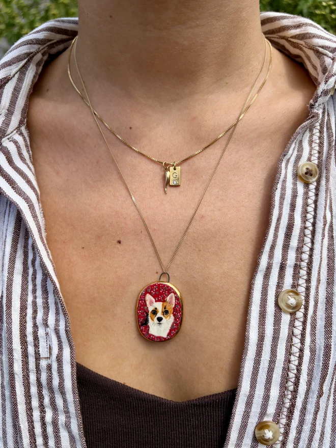 Miniature pet portrait pendant on gold chain. Hand painted ceramic portrait of a dog. 