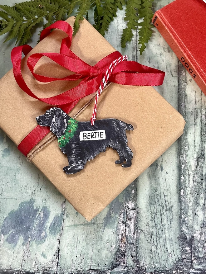 Cocker Spaniel Personalised Christmas Decoration Placed on a wrapped gift