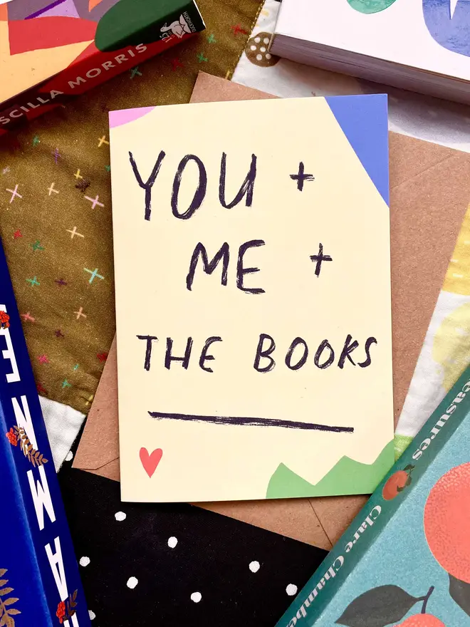 Card on colourful background surrounded by books