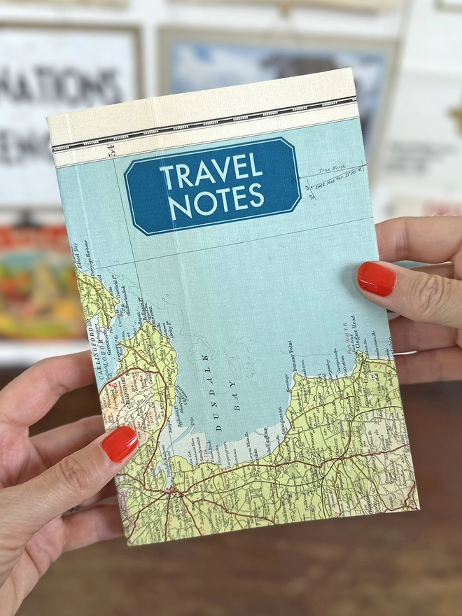 Travel notebook with a vintage map cover and blue printed 'Travel Notes' on the cover