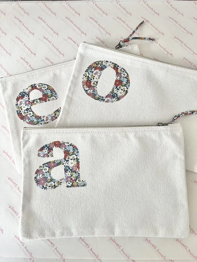 natural make up zip up pouches personalised with a liberty print initial on the front in the corner
