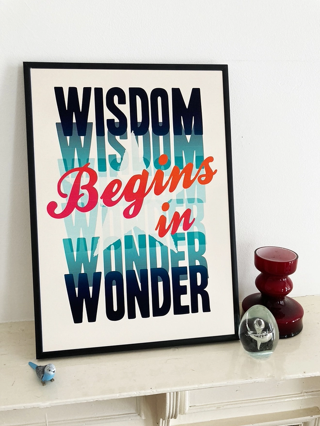 Framed multicoloured typographic print of Socrate’s famous quote - “Wisdom Begins In Wonder”