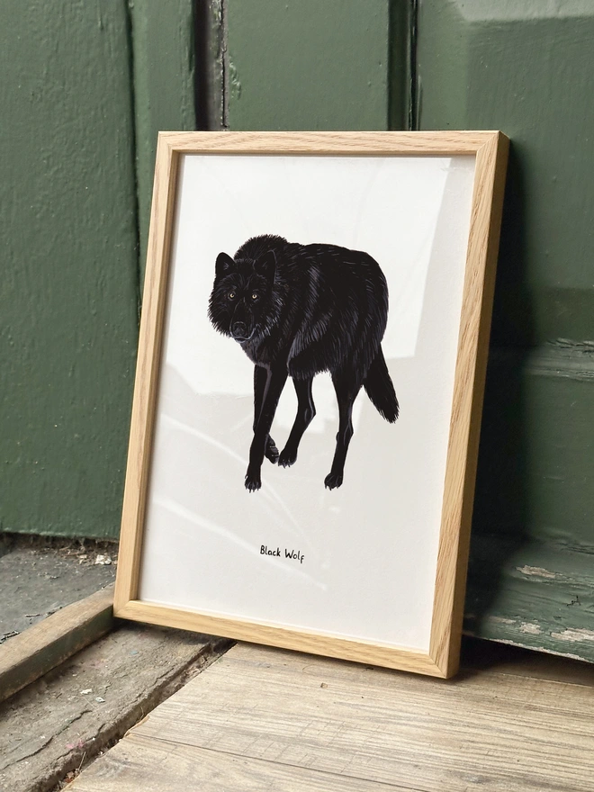 a print featuring a black wolf illustration
