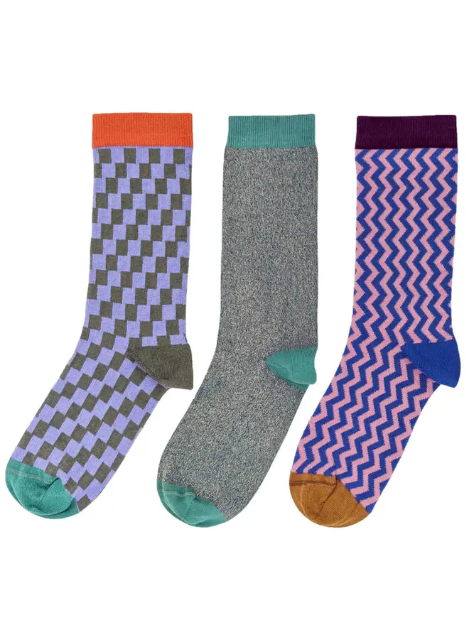 Women's Organic Cotton Ankle Socks Packs (Sets Of 3), a pack of three colourful patterned socks sitting on a plain white surface. 