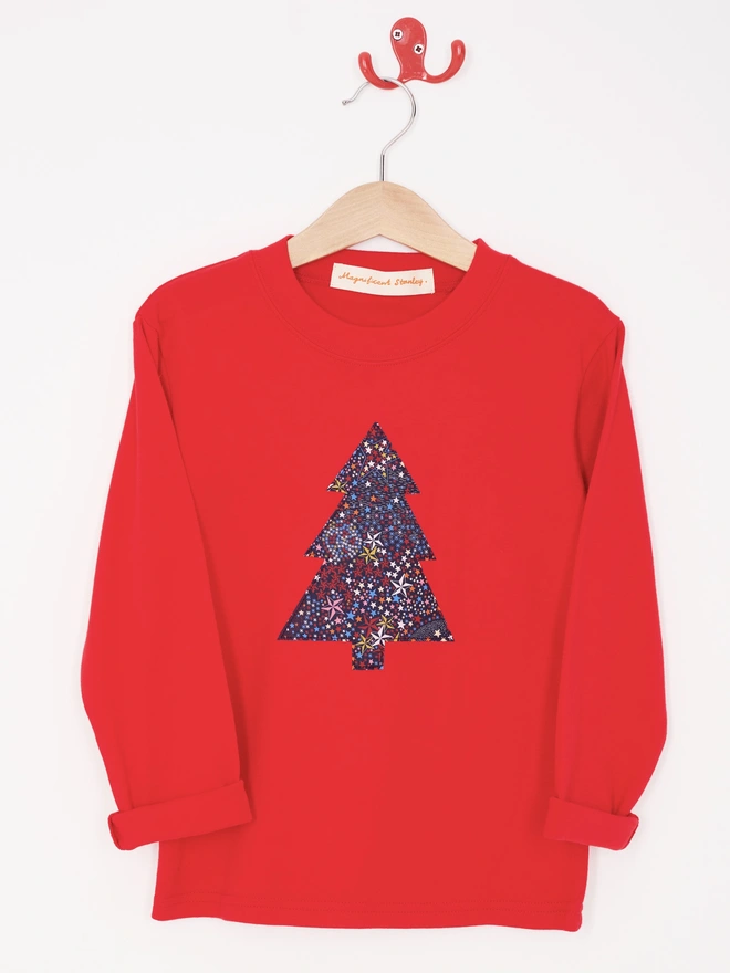 a red tee with a christmas tree cut from starry liberty print sewn onto the front