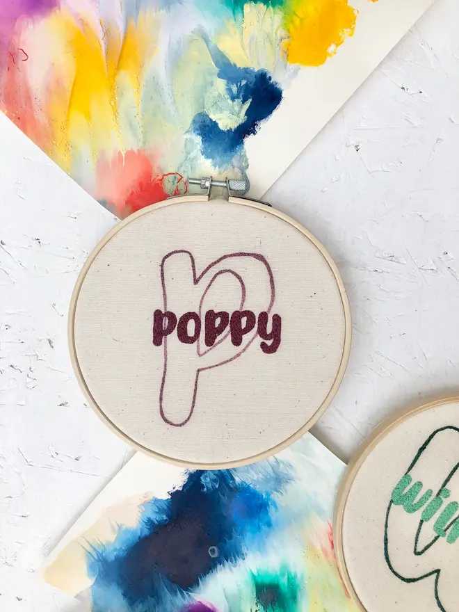 personalised name and initial embroidered hoop. cotton hoop embroidered with name poppy and letter p.