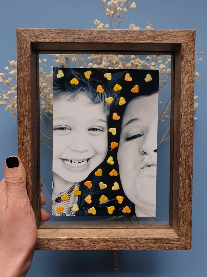  Family photo, with hand embroidered shades of yellow hearts in double glass frame