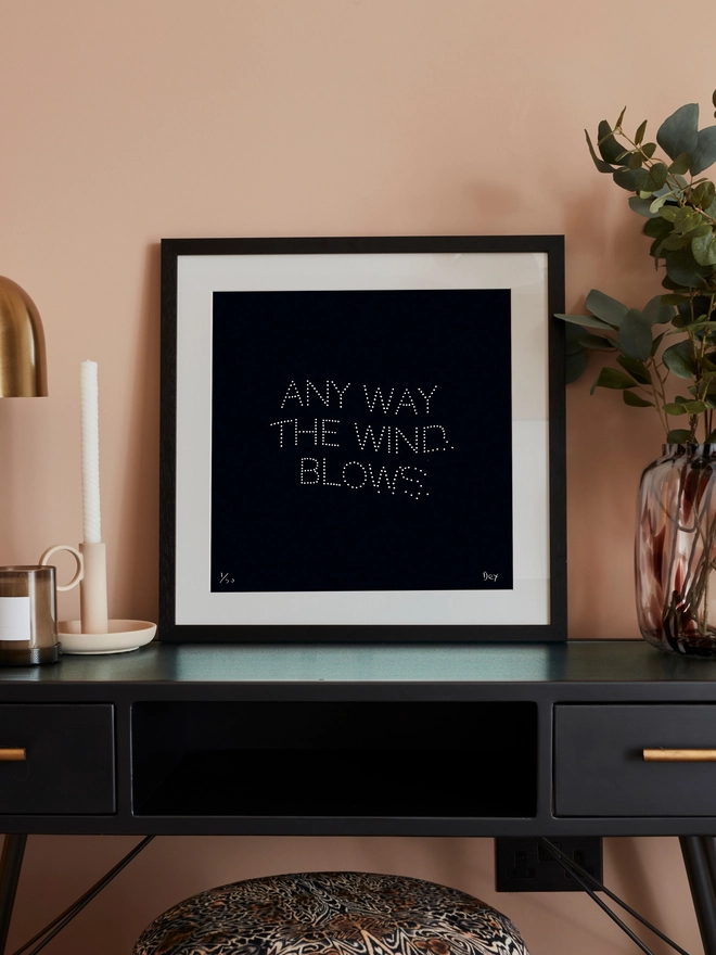 Bohemian Rhapsody lyrics art print on a desk in a frame