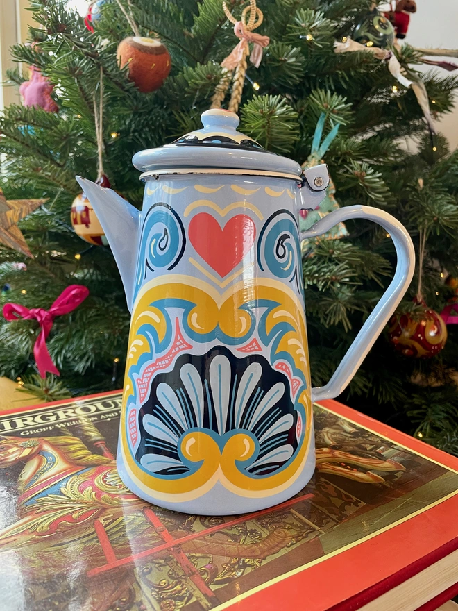 Blue enamel coffee pot hand painted with a fairground design in blue, pink and yellow